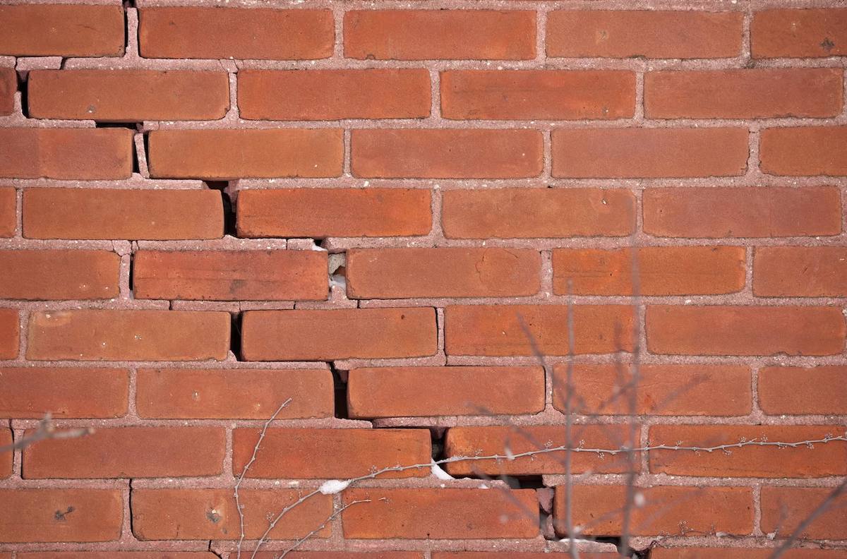 Stepped crack in red brick wall